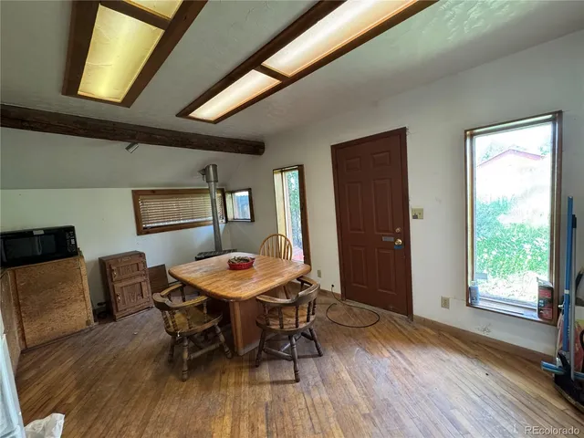 a view of a dining room with furniture window and wooden floor