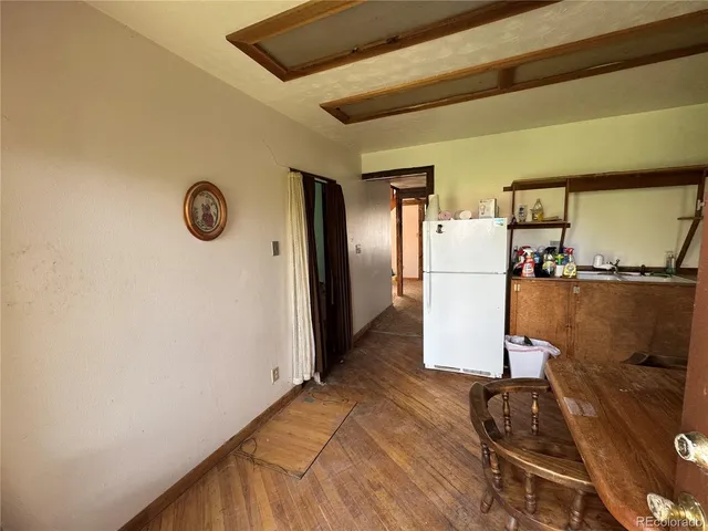 a kitchen with a refrigerator and a stove