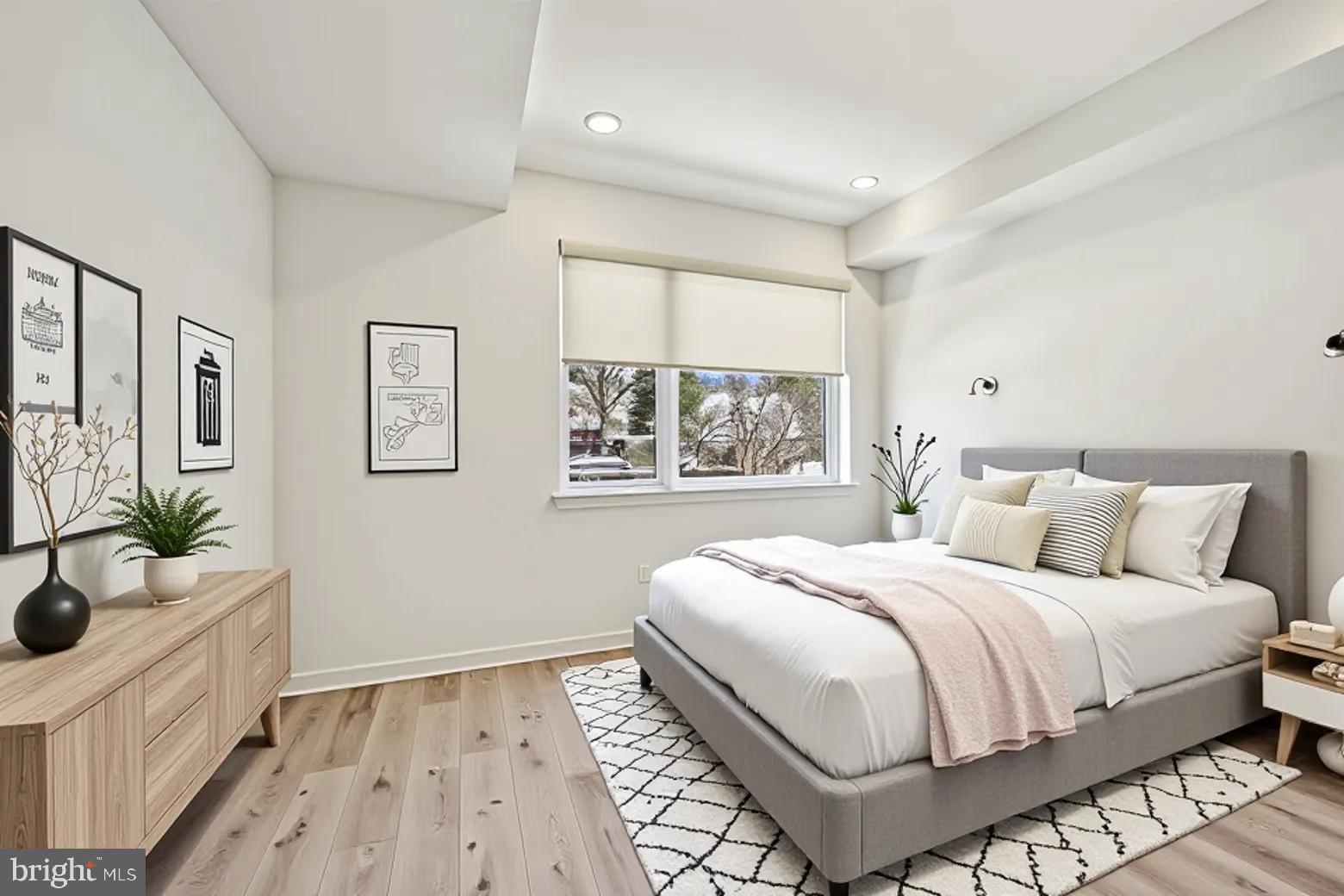 23 Rock Hill Road, Unit 201 Bala Cynwyd, PA 19004 - Photo 2 of 8 a bedroom with a large bed and a window