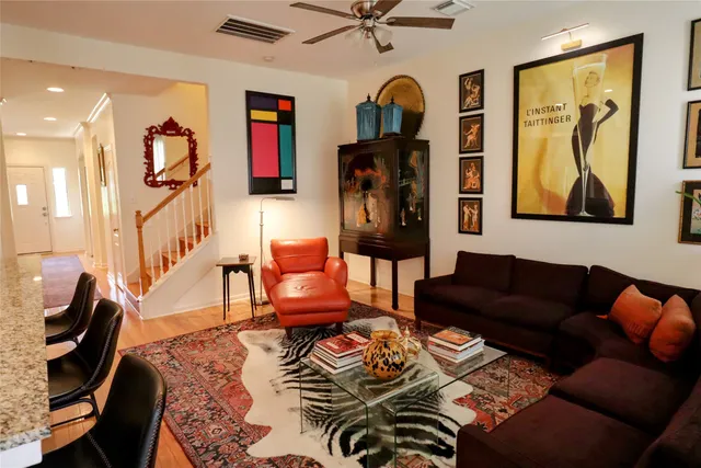 a living room with furniture and wooden floor