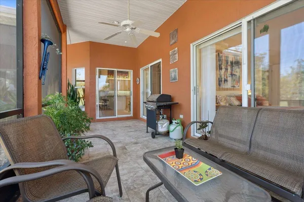 a view of house with yard and outdoor seating
