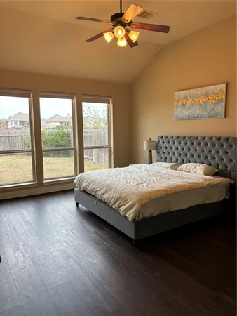 a bedroom with a large bed and a large window