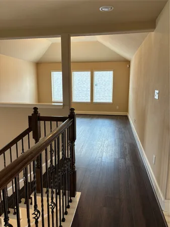 a view of hallway with wooden floor