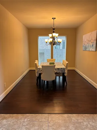 a view of a dining room with furniture and chandelier