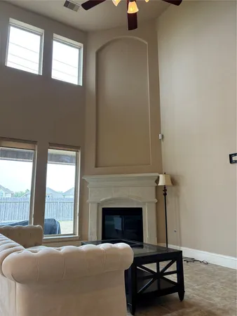 a living room with furniture and a fireplace