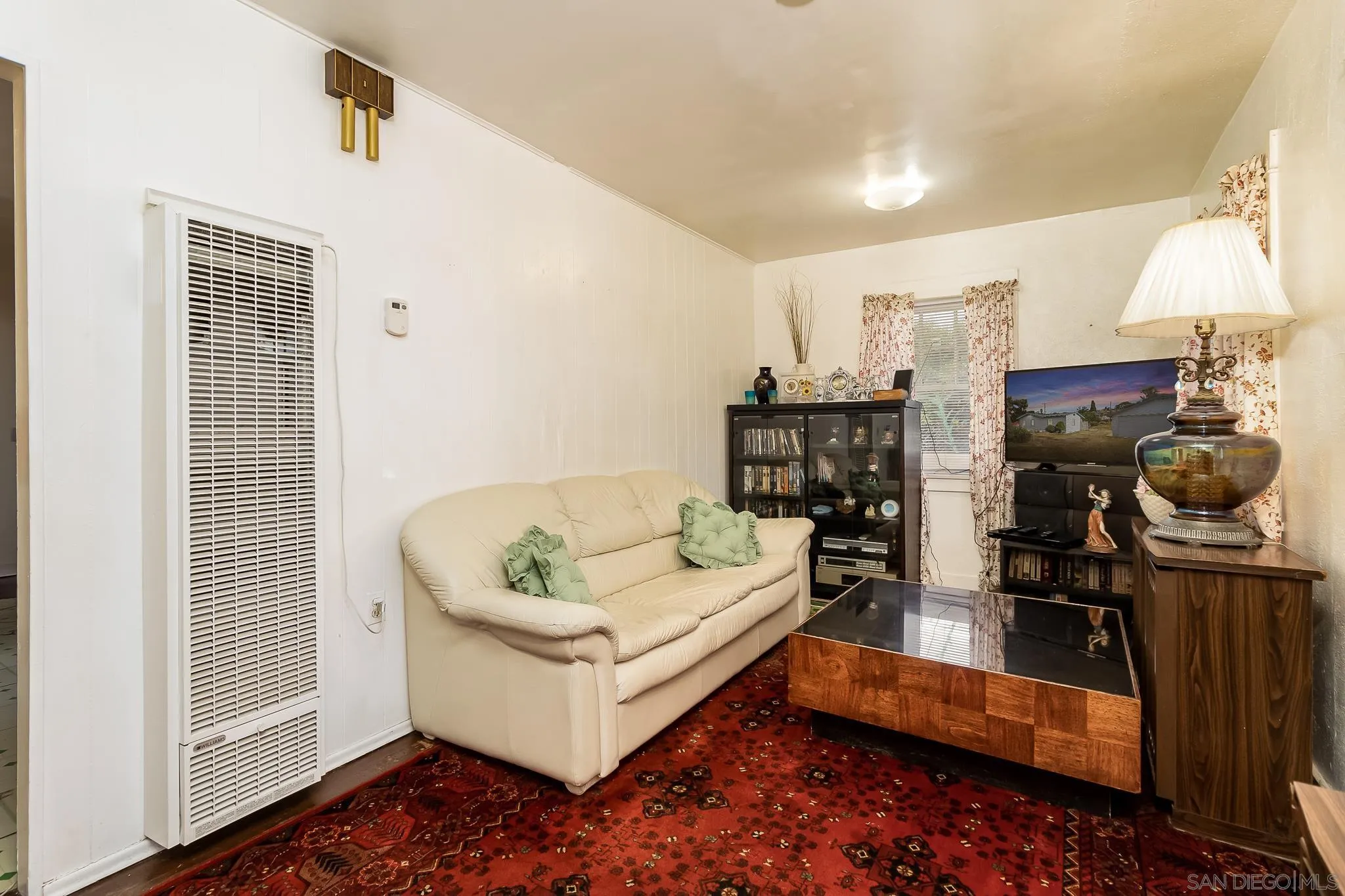 7054 Lisbon Street San Diego, CA 92114 - Photo 13 of 38 a living room with furniture and a fireplace