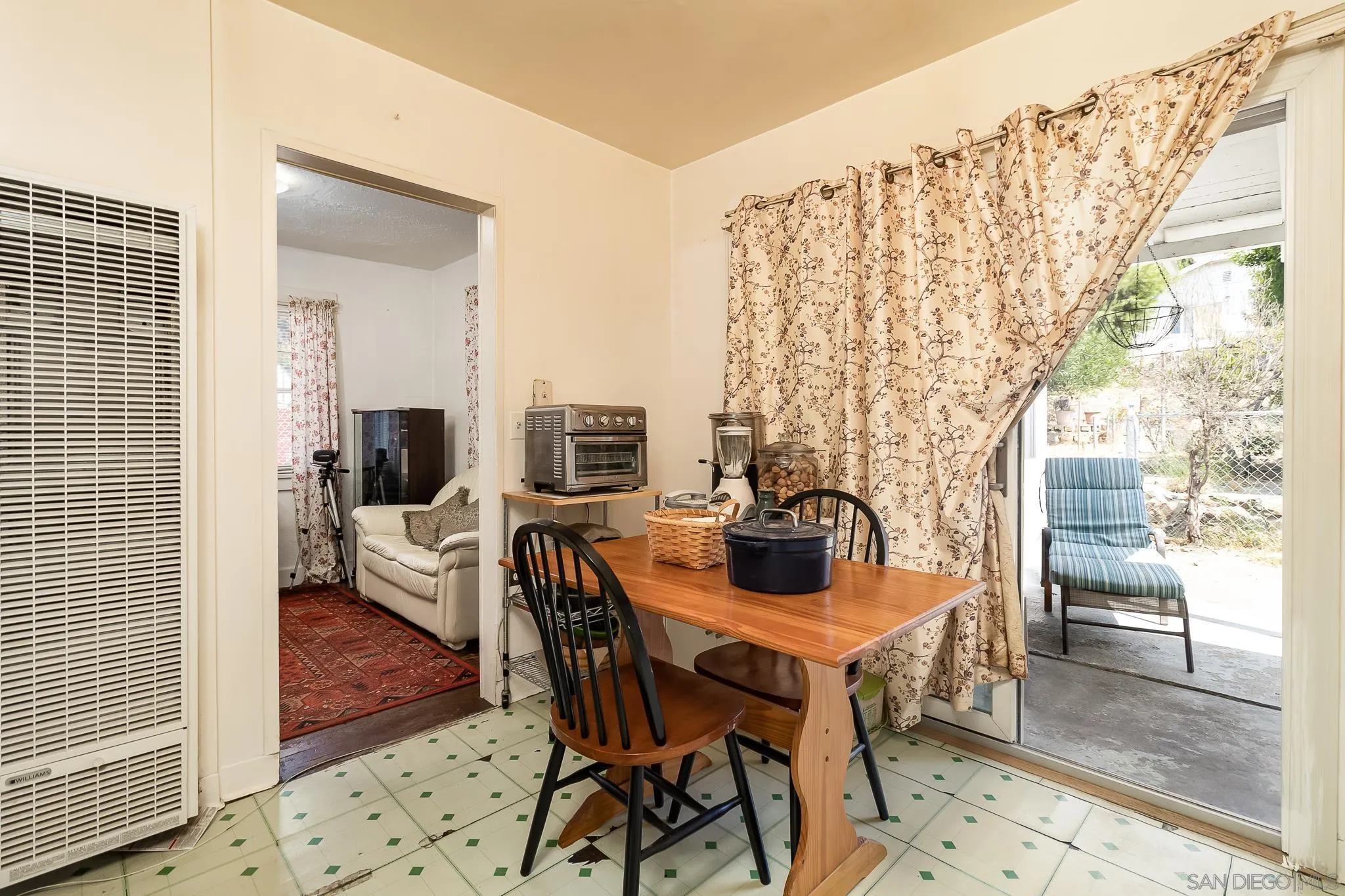 7054 Lisbon Street San Diego, CA 92114 - Photo 17 of 38 a dining room with furniture and wooden floor