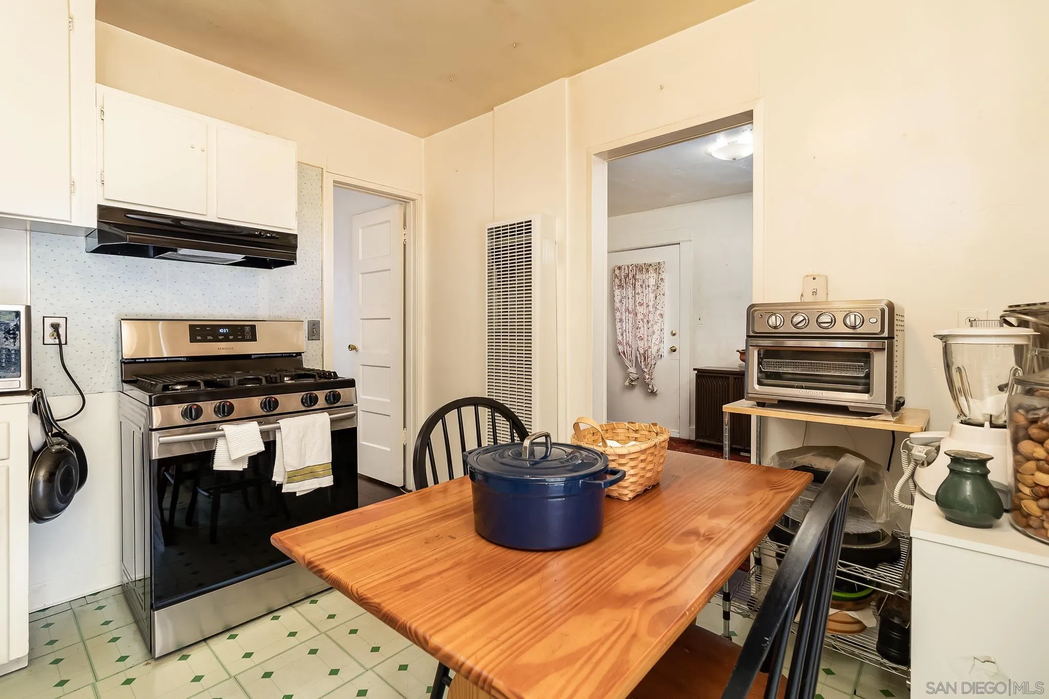 7054 Lisbon Street San Diego, CA 92114 - Photo 18 of 38 a kitchen with a stove and a refrigerator
