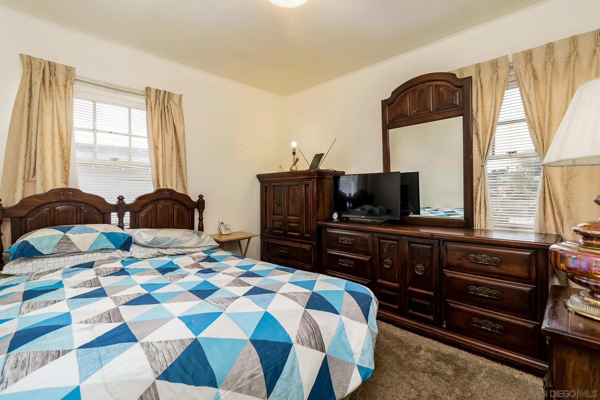 7054 Lisbon Street San Diego, CA 92114 - Photo 20 of 38 a bedroom with a bed and a television