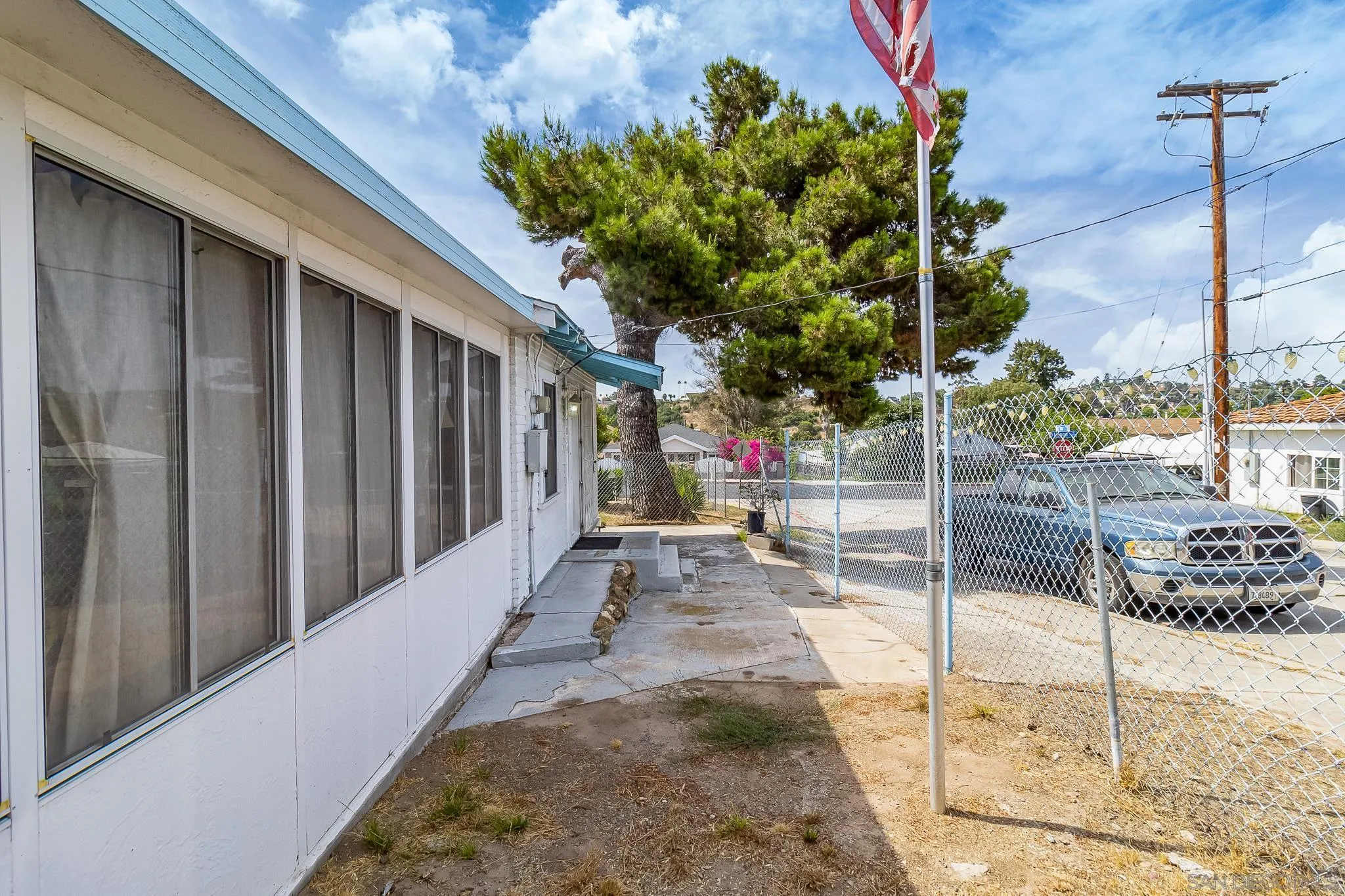 7054 Lisbon Street San Diego, CA 92114 - Photo 8 of 38 a view of a porch with a tree