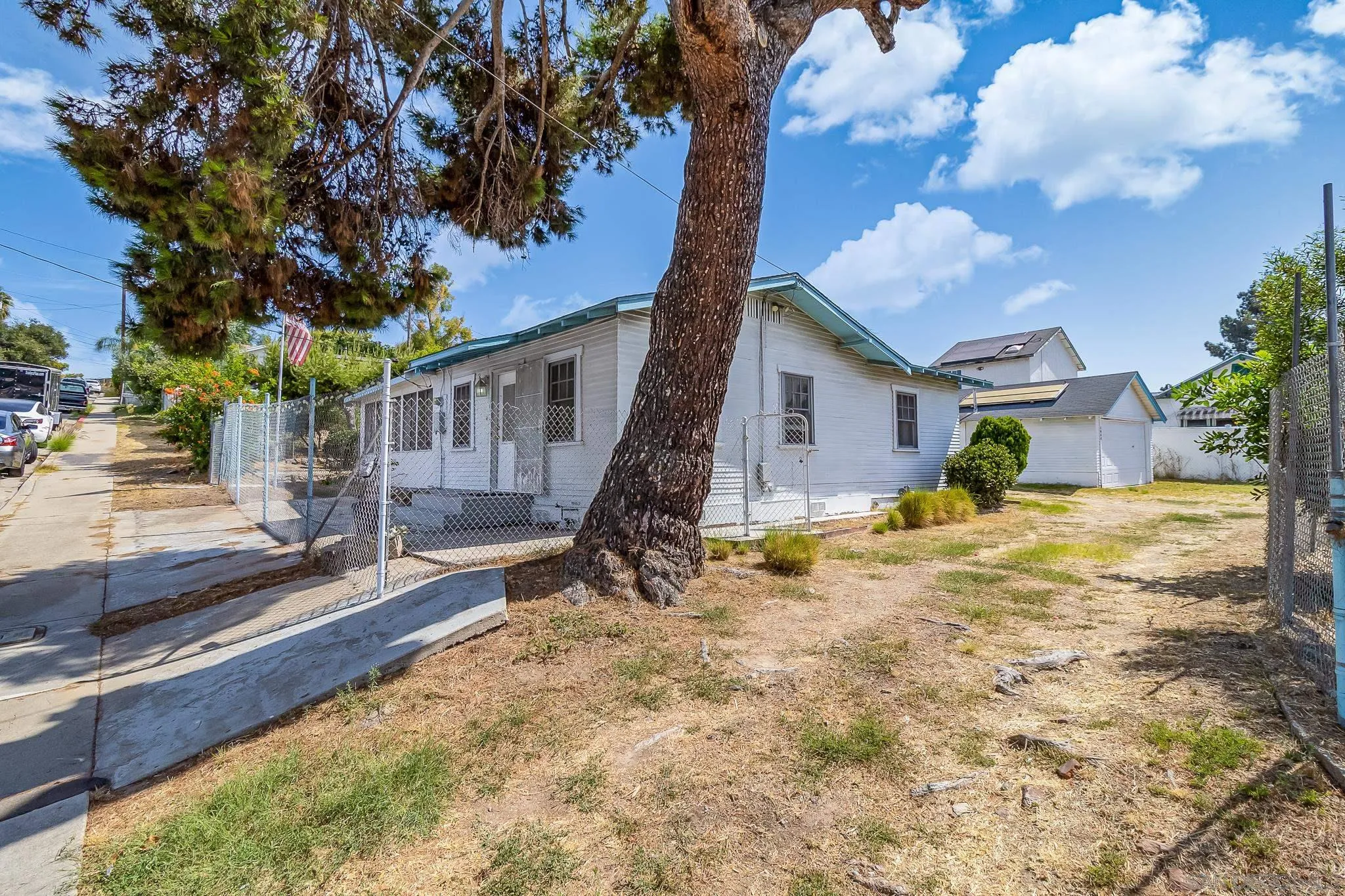 7054 Lisbon Street San Diego, CA 92114 - Photo 9 of 38 a view of a house with backyard and trees