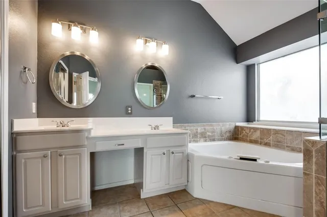 a bathroom with a double vanity sink and a mirror