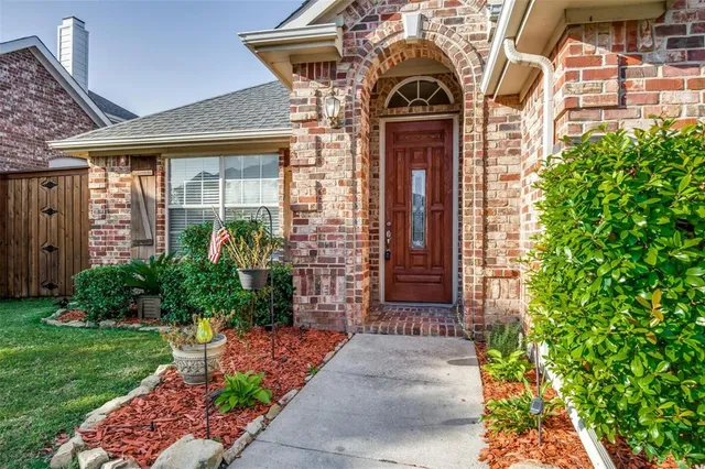 a view of entrance of the house with a yard