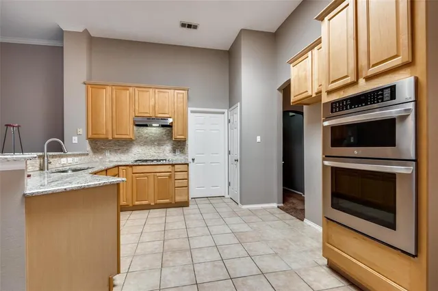 a kitchen with a sink stove and cabinets