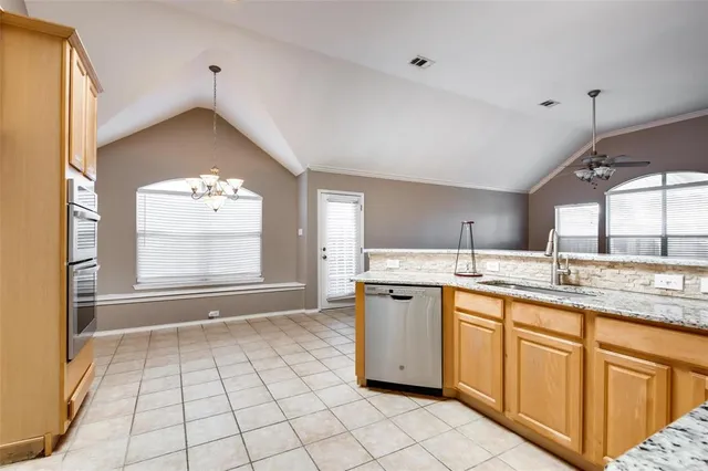a kitchen with granite countertop a sink stainless steel appliances and cabinets
