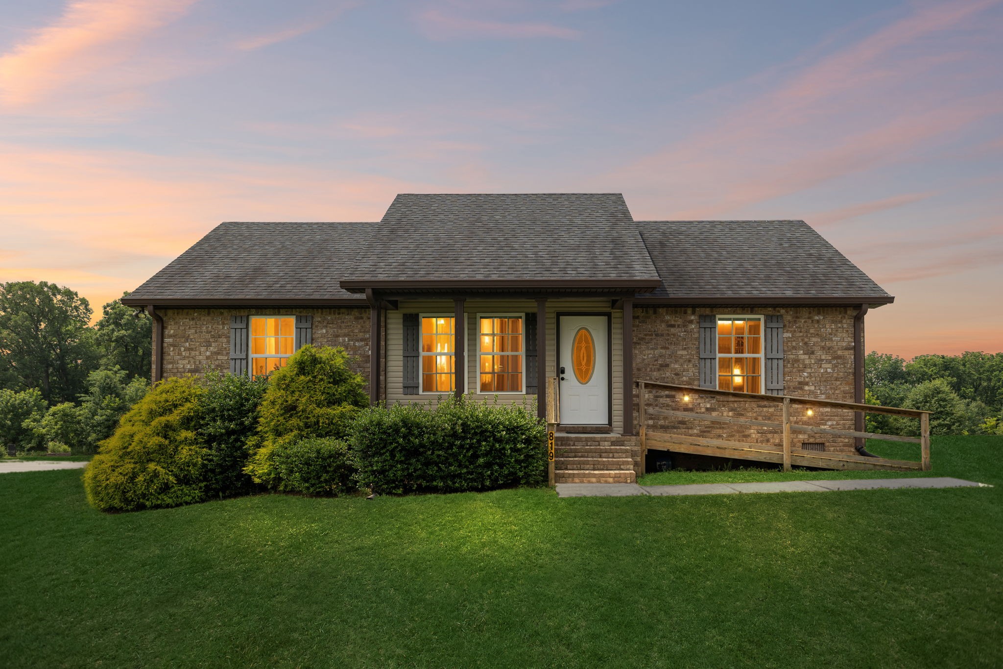 a front view of a house with a garden