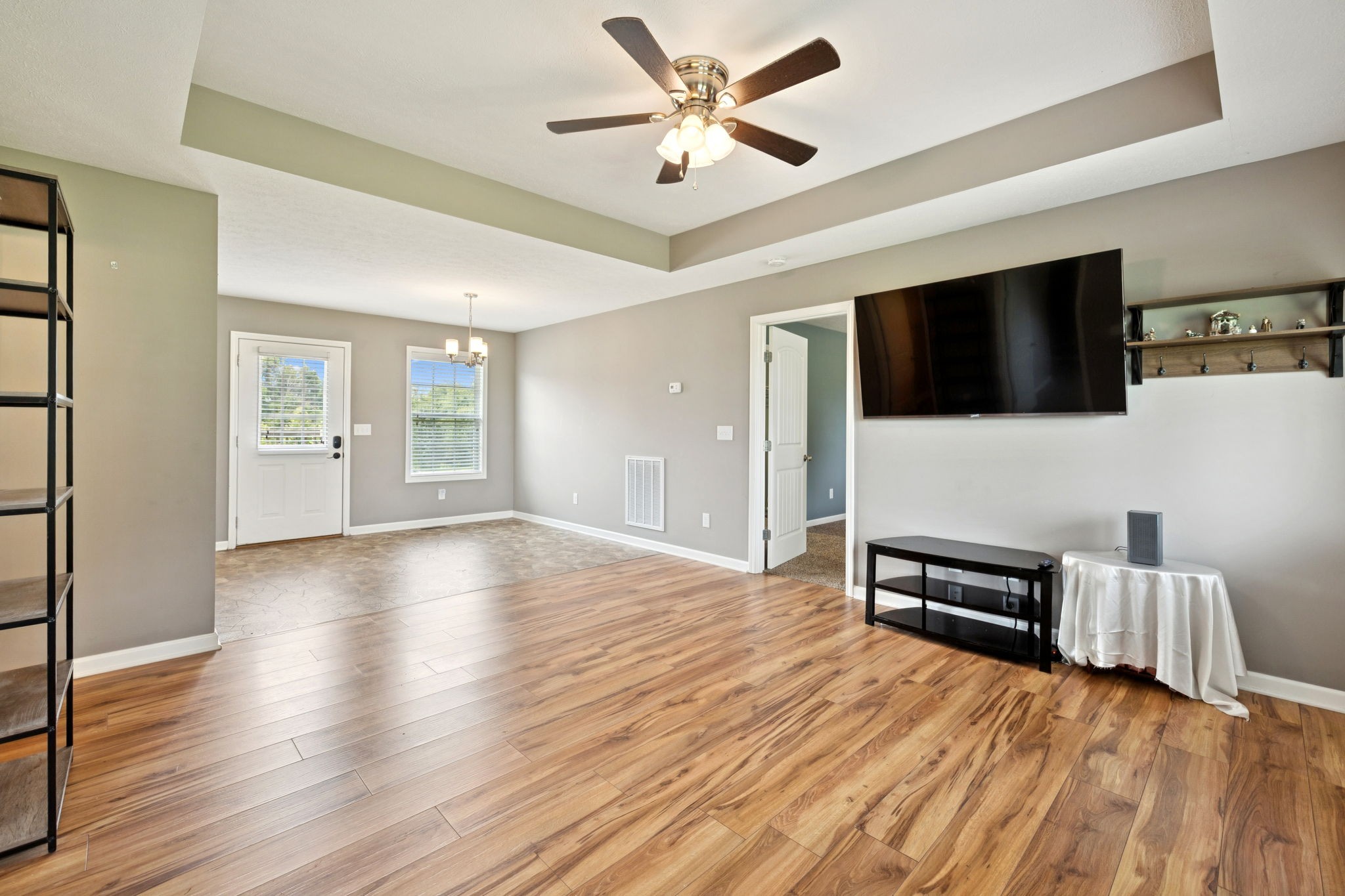819 White Road Portland, TN 37148 - Photo 4 of 21 a view of a livingroom with a flat screen tv wooden floor and a ceiling fan