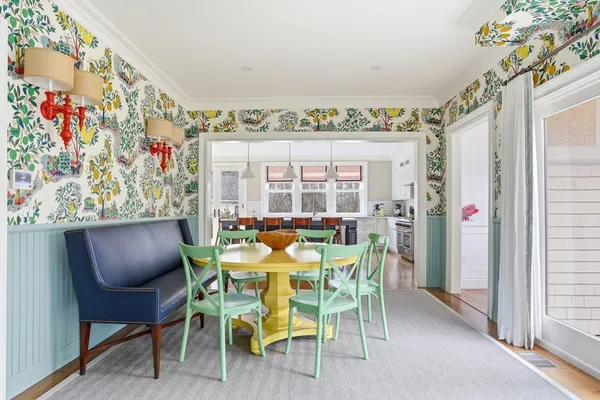 a dining room with furniture and a large window
