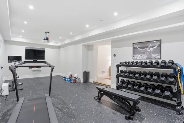 a room with furniture a piano and a ceiling fan