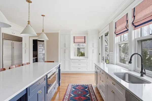 a kitchen with granite countertop a sink a counter top space and cabinets