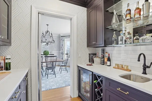a kitchen with a refrigerator and a sink