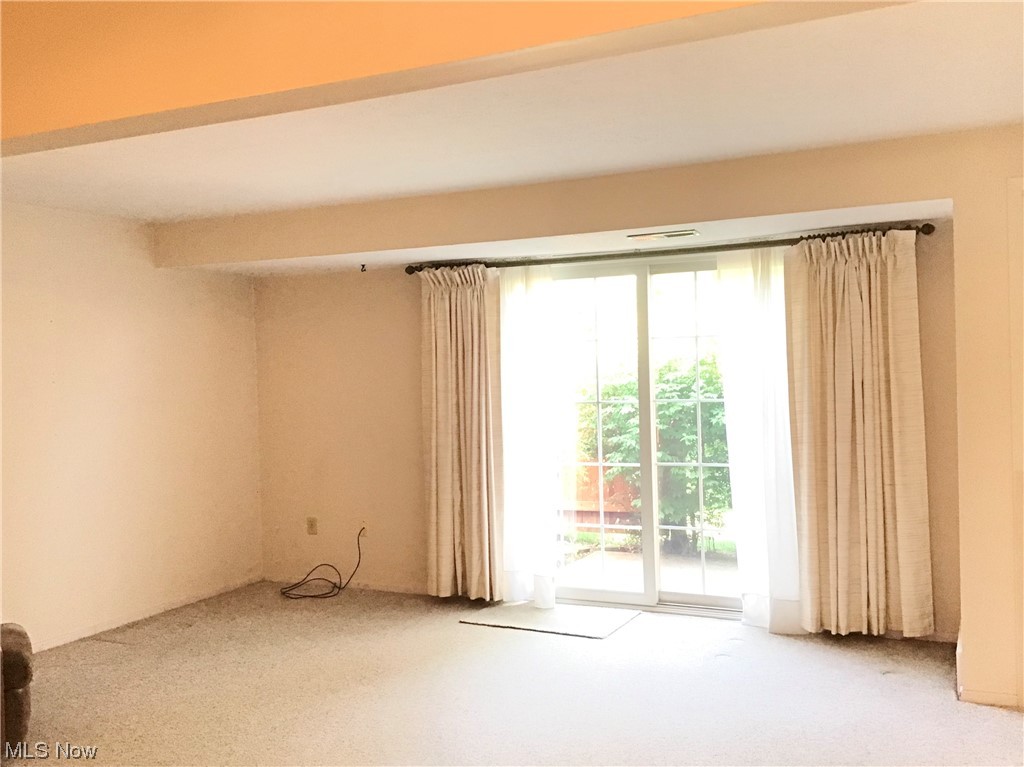 8947 West Ridge Road, Unit C Elyria, OH 44035 - Photo 2 of 27 Living room features view to patio. Neutral decor.