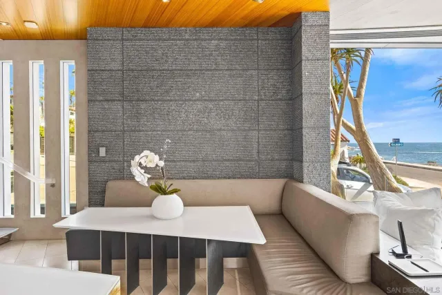 a living room with furniture and a floor to ceiling window