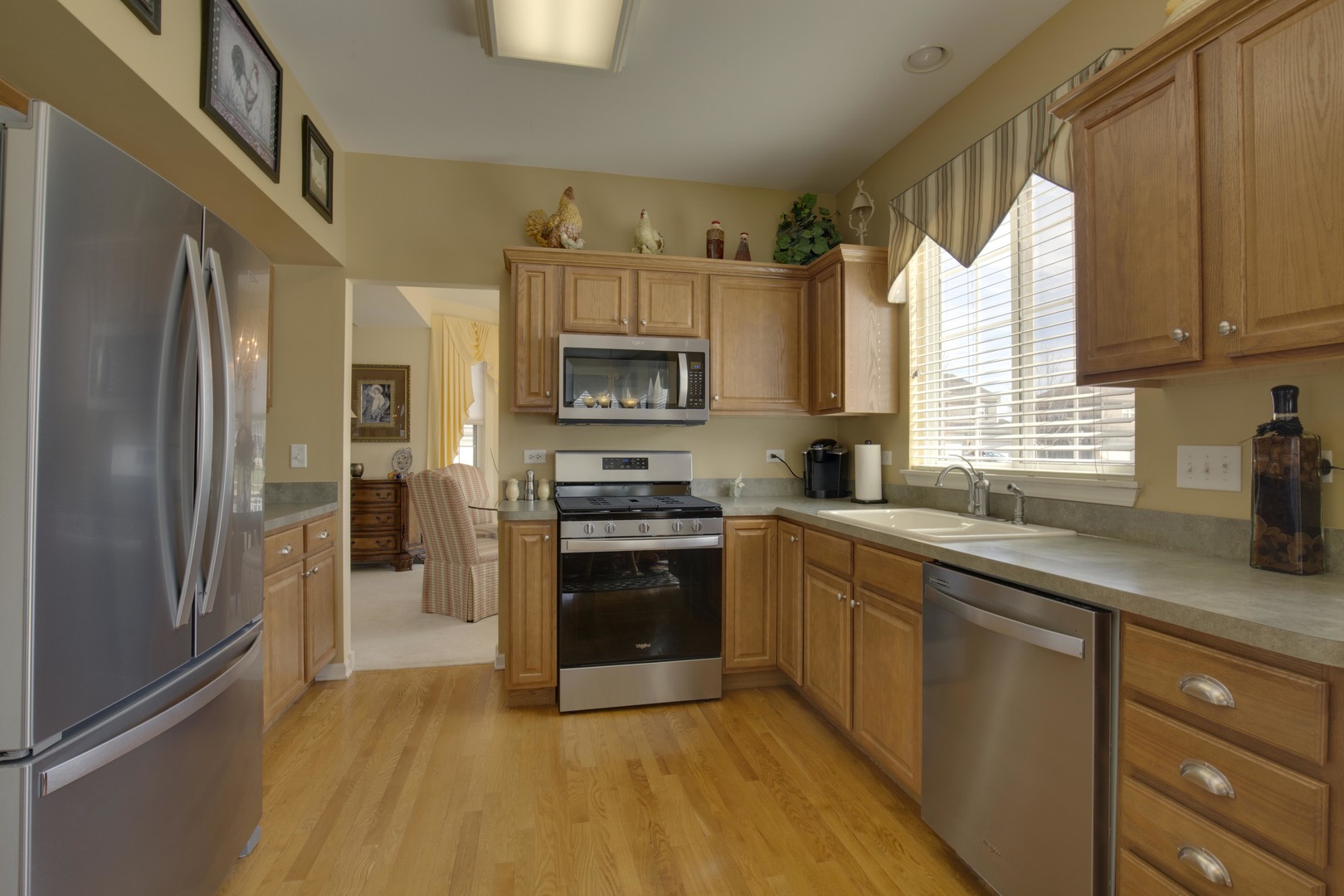 9610 Newton Road Huntley, IL 60142 - Photo 11 of 23 a kitchen with stainless steel appliances granite countertop a refrigerator a sink dishwasher a stove top oven a refrigerator and cabinets