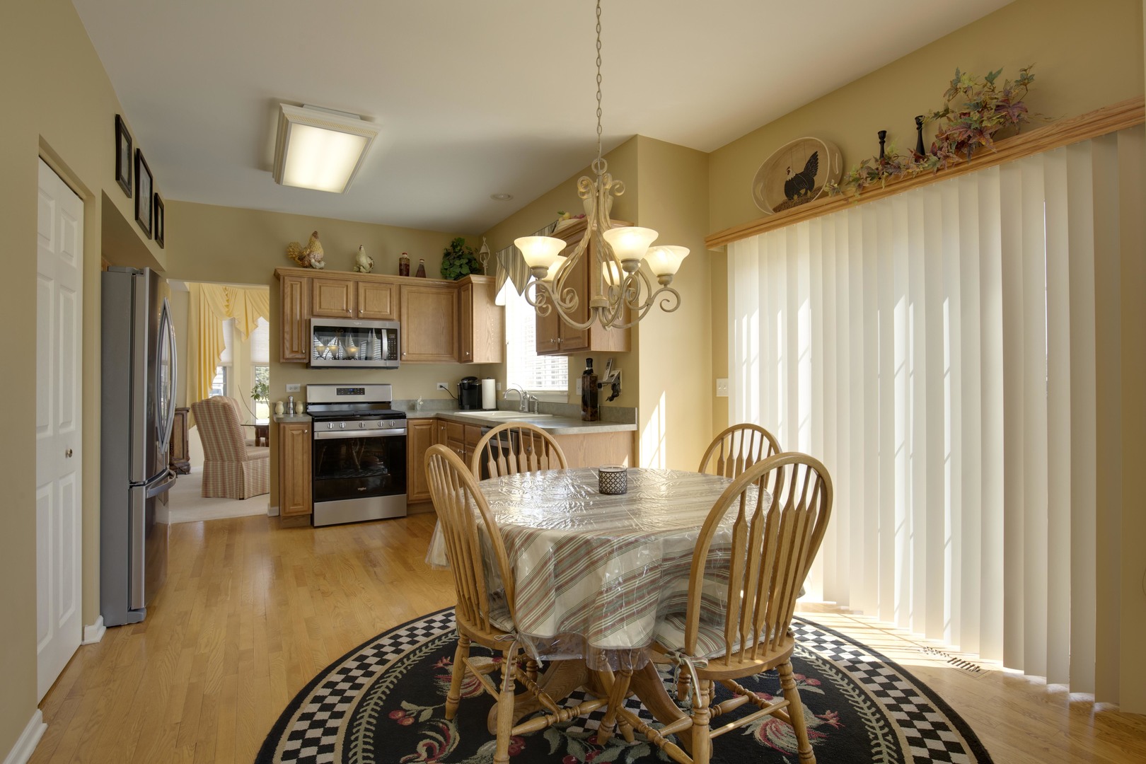 9610 Newton Road Huntley, IL 60142 - Photo 12 of 23 a dining room with furniture and a kitchen view