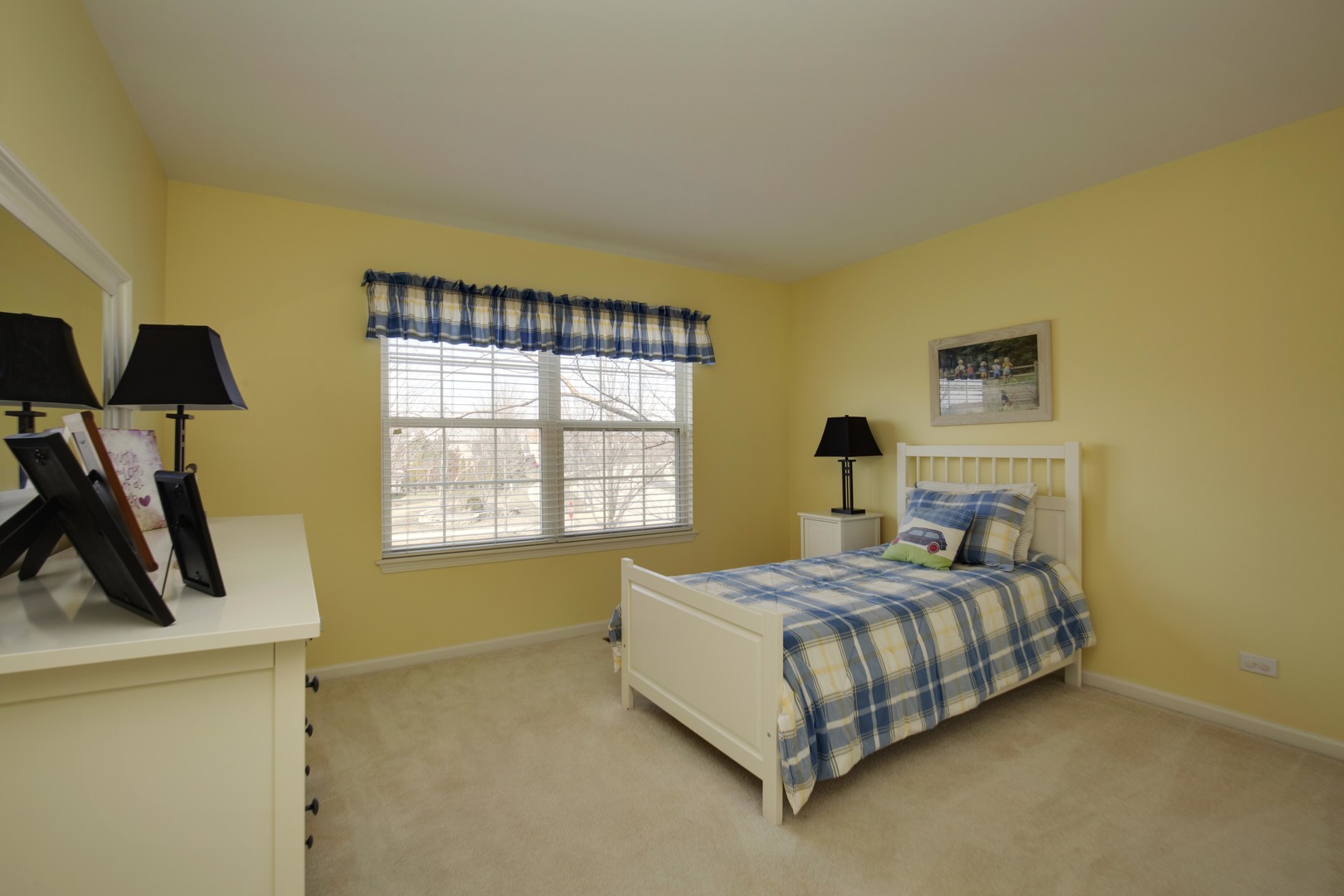 9610 Newton Road Huntley, IL 60142 - Photo 18 of 23 a bedroom with a bed and dresser with mirror