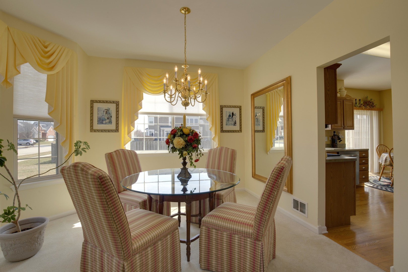 9610 Newton Road Huntley, IL 60142 - Photo 9 of 23 a view of a dining room with furniture a chandelier and wooden floor