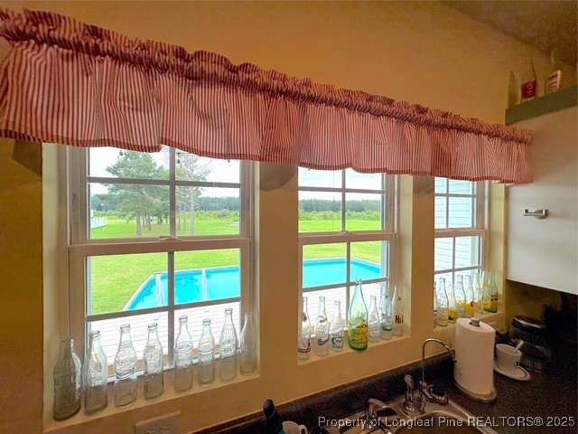 893 Blanchard Road St. Pauls, NC 28384 - Photo 12 of 32 a room with furniture a flat screen tv and a floor to ceiling window