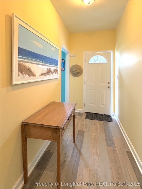 893 Blanchard Road St. Pauls, NC 28384 - Photo 26 of 32 a view of a hallway with wooden floor and dining room view