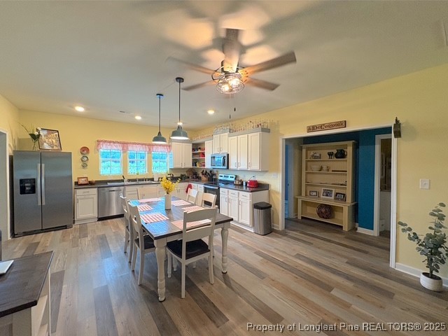 893 Blanchard Road St. Pauls, NC 28384 - Photo 9 of 32 a room with stainless steel appliances kitchen island granite countertop a table chairs and a refrigerator