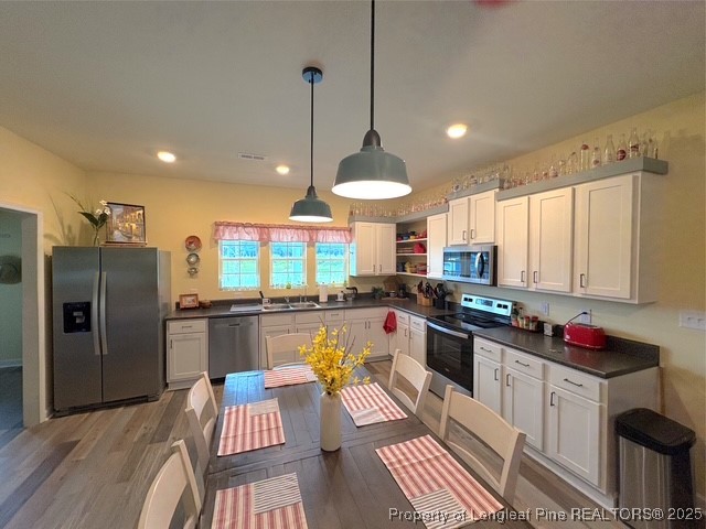 893 Blanchard Road St. Pauls, NC 28384 - Photo 10 of 32 a kitchen with stainless steel appliances granite countertop a stove refrigerator and cabinets
