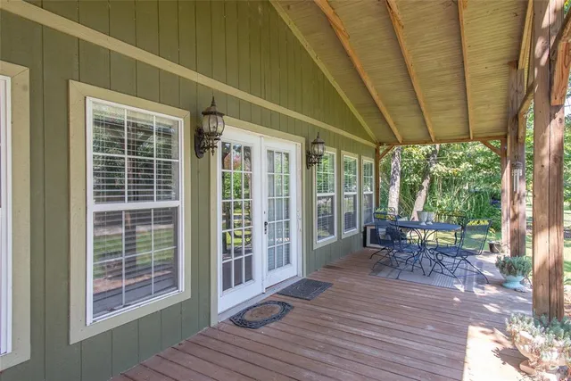 a balcony with chairs and wooden floor