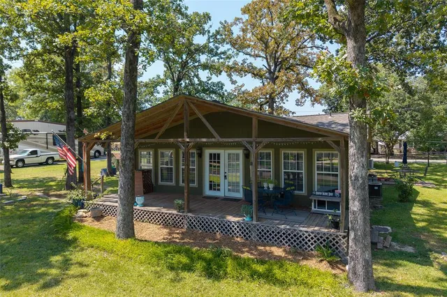 a view of a house with backyard porch and sitting area
