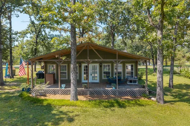 a view of a house with a yard patio and fire pit