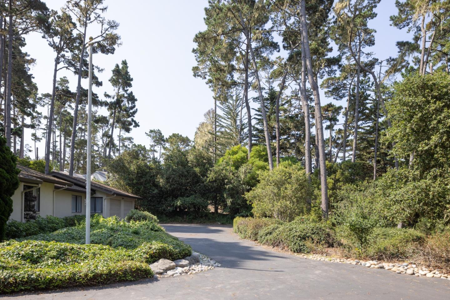 3171 Forest Lake Road Pebble Beach, CA 93953 - Photo 8 of 17 a backyard of a house with outdoor seating and plants