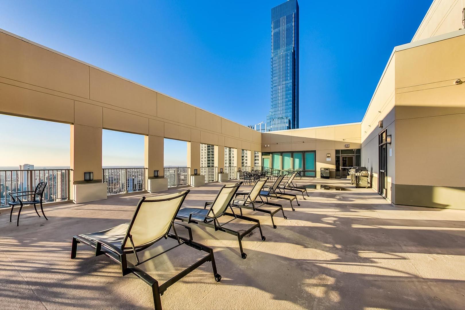 2 East Erie Street, Unit 2204 Chicago, IL 60611 - Photo 18 of 19 a view of a patio with chairs and tables