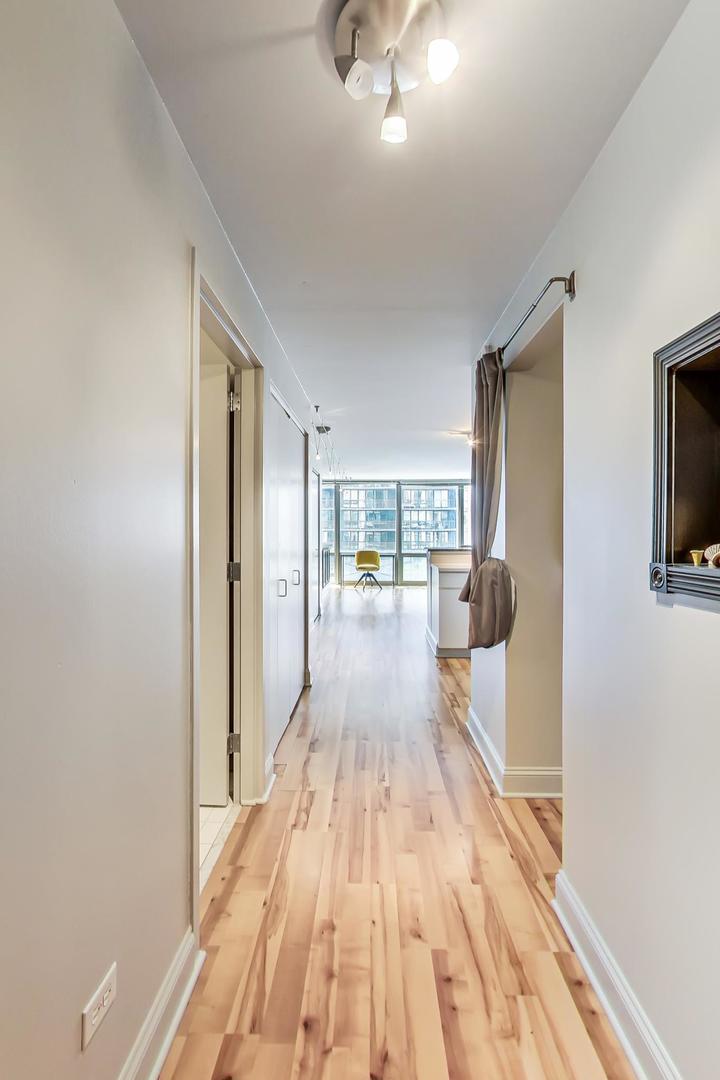 2 East Erie Street, Unit 2204 Chicago, IL 60611 - Photo 3 of 19 a view of a living room hardwood floor and a kitchen
