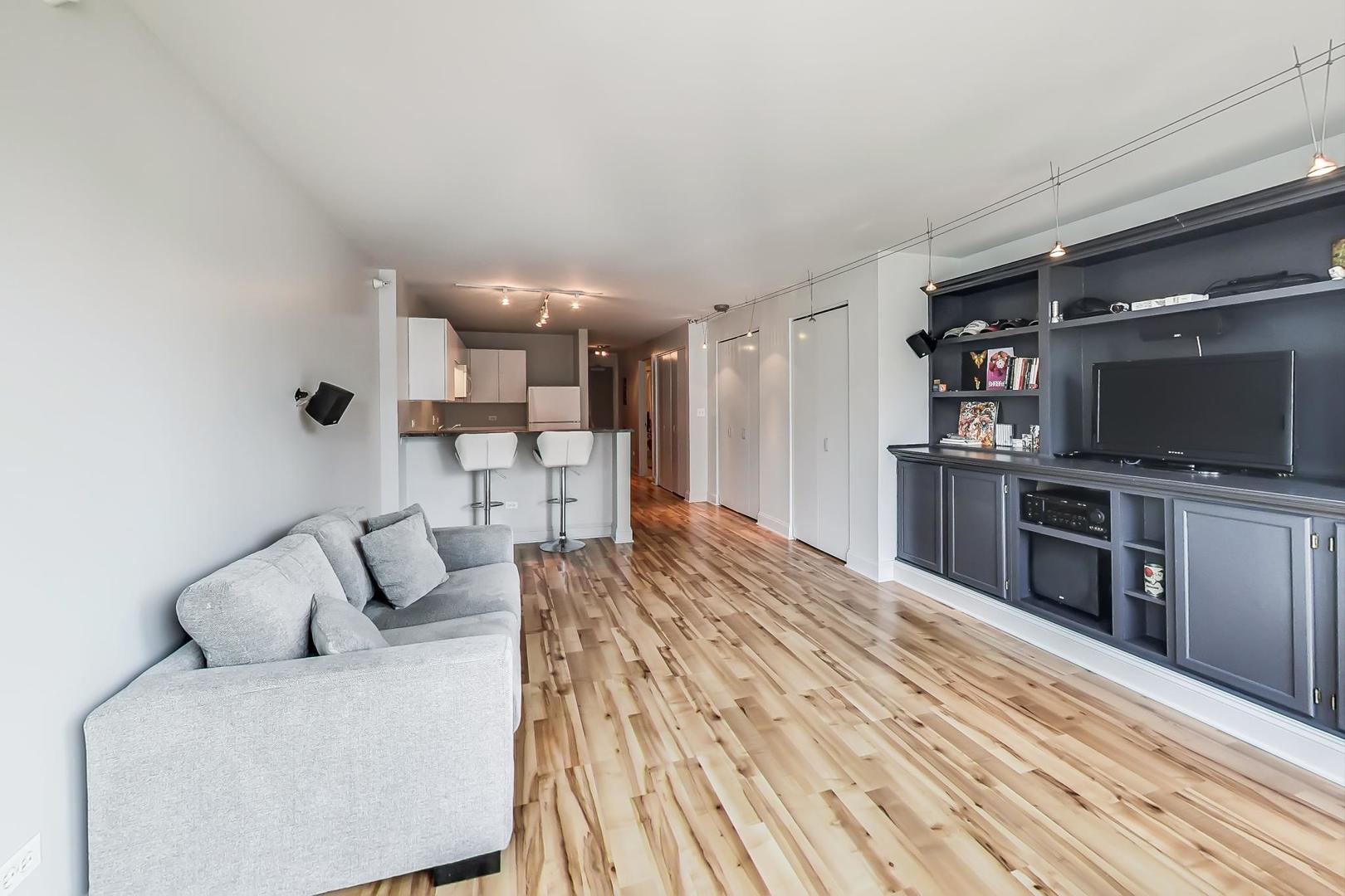 2 East Erie Street, Unit 2204 Chicago, IL 60611 - Photo 6 of 19 a living room with furniture and a flat screen tv