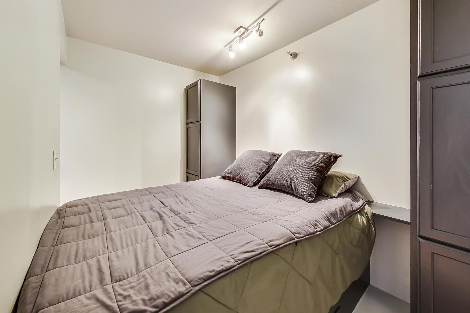 2 East Erie Street, Unit 2204 Chicago, IL 60611 - Photo 10 of 19 a bedroom with a bed and a mirror