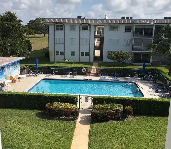 5401 Northwest 2nd Avenue, Unit 219 Boca Raton, FL 33487 - Photo 11 of 15 a view of a house with a swimming pool
