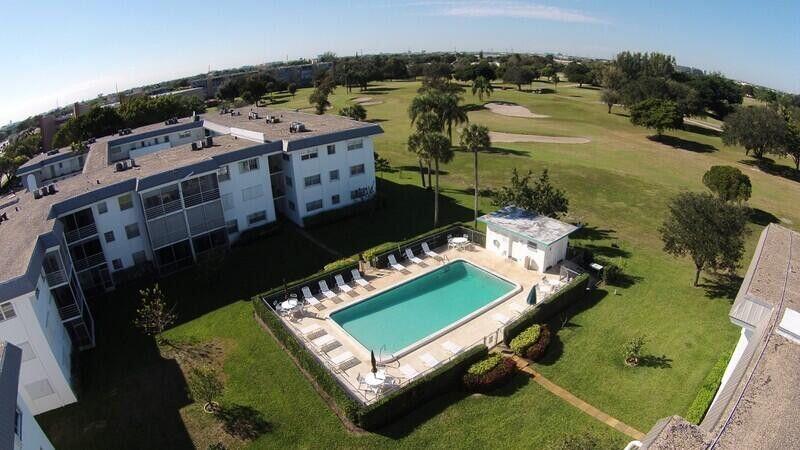 5401 Northwest 2nd Avenue, Unit 219 Boca Raton, FL 33487 - Photo 12 of 15 an aerial view of a pool with a yard