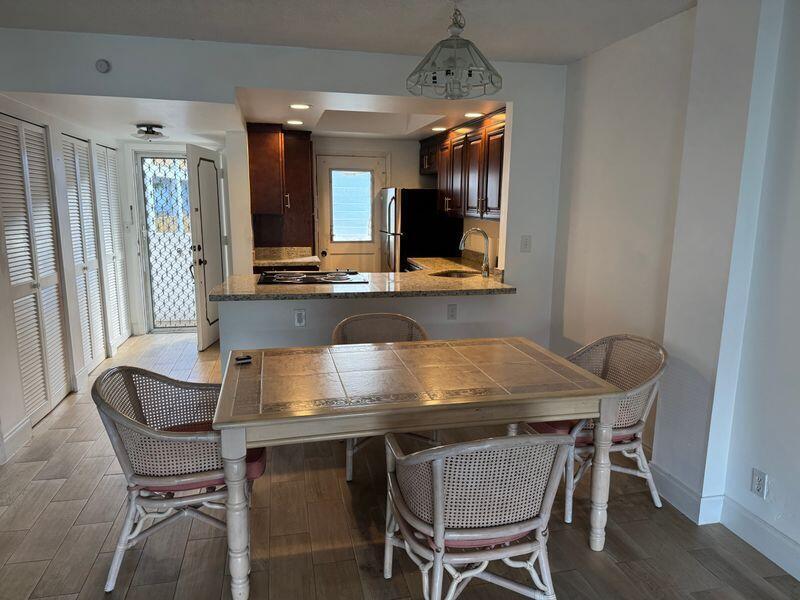 5401 Northwest 2nd Avenue, Unit 219 Boca Raton, FL 33487 - Photo 3 of 15 a room with chairs and a table