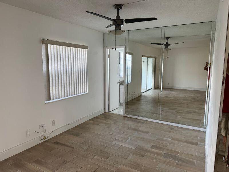 5401 Northwest 2nd Avenue, Unit 219 Boca Raton, FL 33487 - Photo 6 of 15 an empty room with windows and entrance