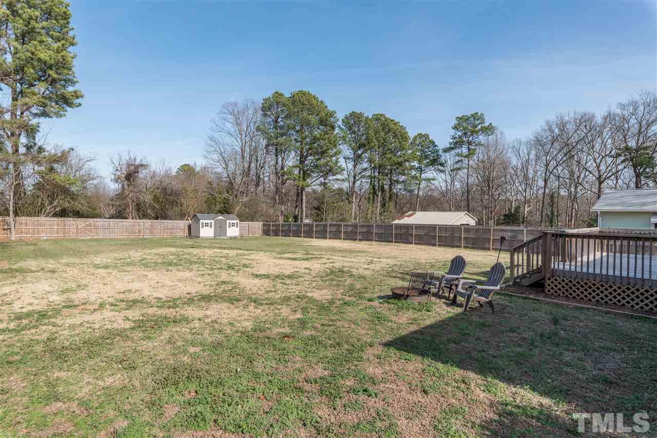 8608 Stonegate Drive Raleigh, NC 27615 - Photo 22 of 25 a view of a lake with a yard
