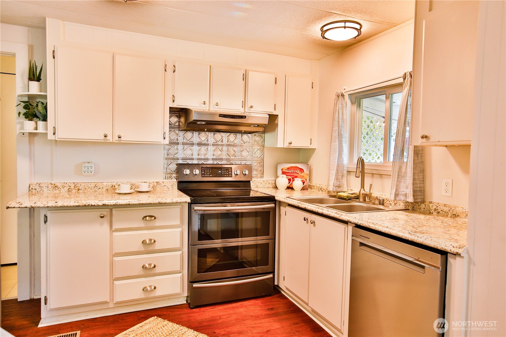 3276 East Harbor Road Langley, WA 98260 - Photo 15 of 37 a kitchen with stainless steel appliances granite countertop a stove and a sink