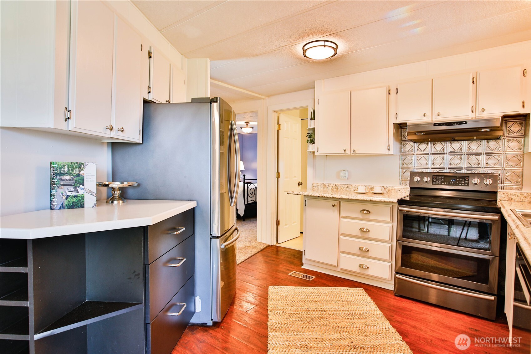 3276 East Harbor Road Langley, WA 98260 - Photo 16 of 37 a kitchen with stainless steel appliances a stove a sink and cabinets